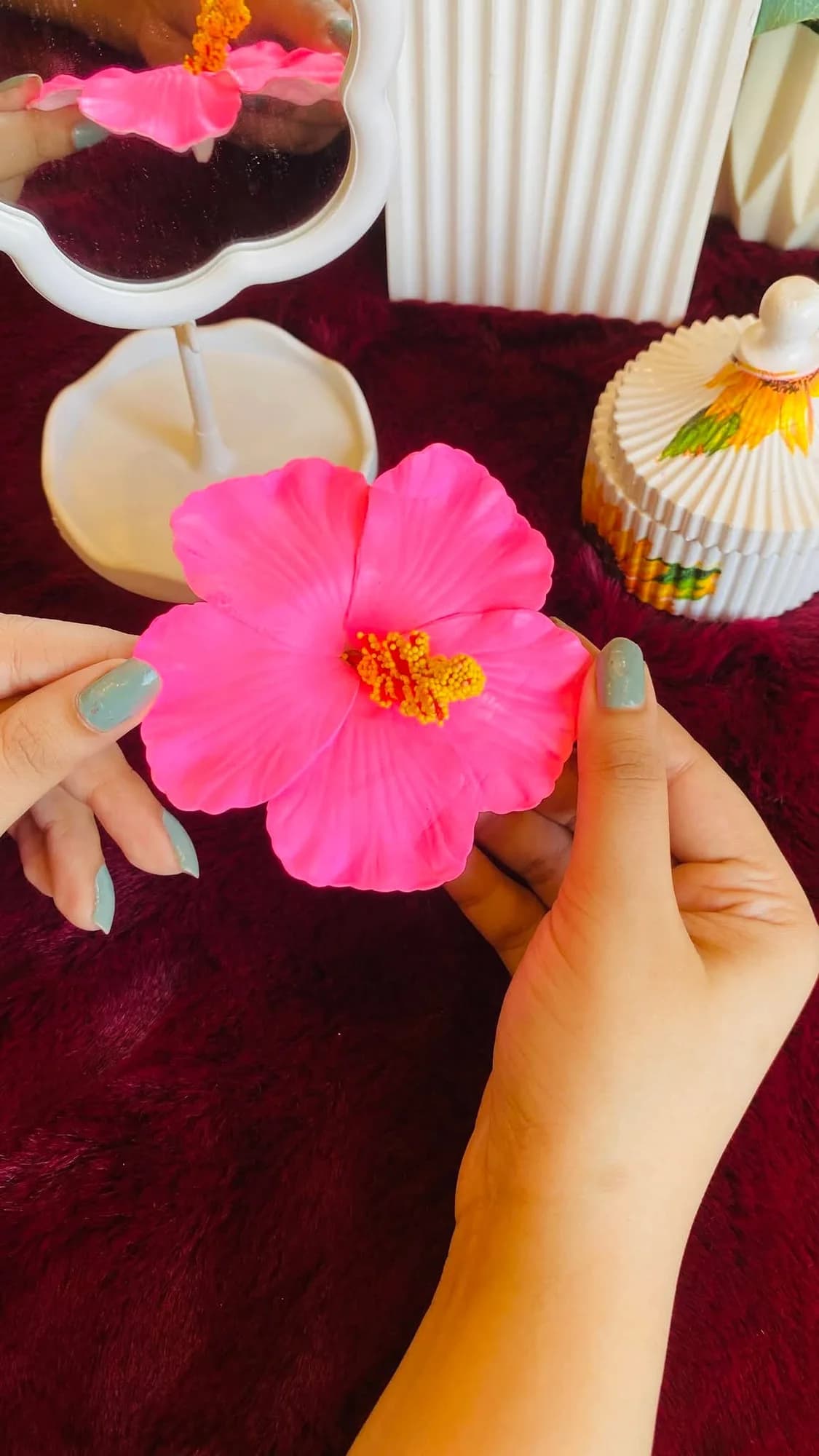 Pink hibiscus clip, held in hand